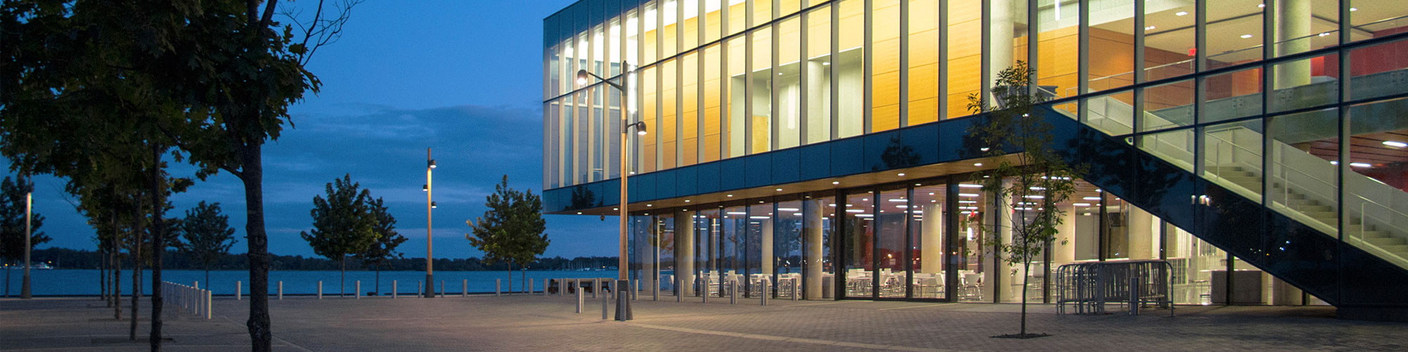 Exterior of Waterfront Campus, panned out with tree framing the side.
